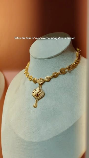 Gold necklace on a velvet bust