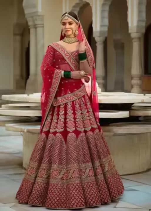 Bride in a red embroidered lehenga with dupatta
